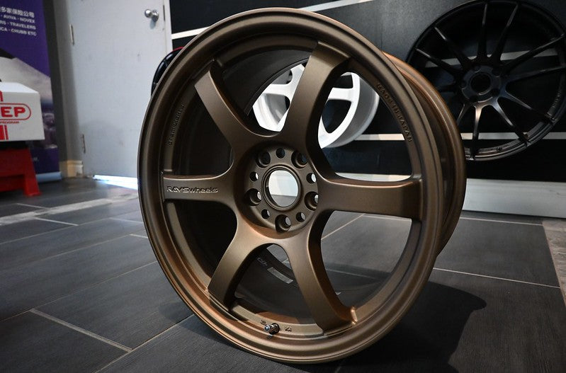 Bronze-colored alloy wheel with multi-spoke design and black center cap for WRX STI