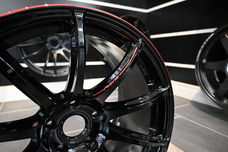 Glossy black and red RAYS Gram Lights 57Transcend Rev Limit alloy wheel