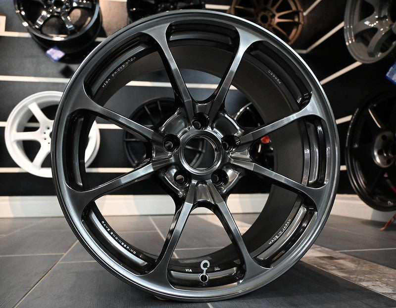 20-inch black Rays Volk NE24 wheel with multi-spoke design and red calipers