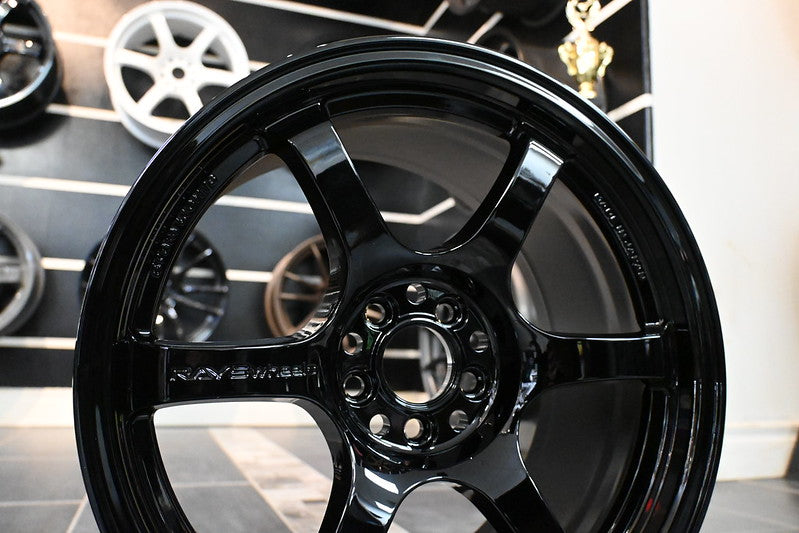Glossy black RAYS Gram Lights 57DR racing wheel with silver accents