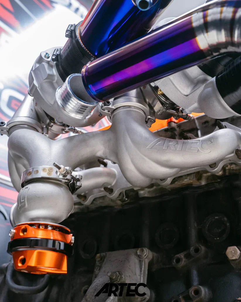 Silver Artec turbocharger in blue-purple metallic finish with orange accents for Toyota 2JZ-GTE Twin Turbo Kit